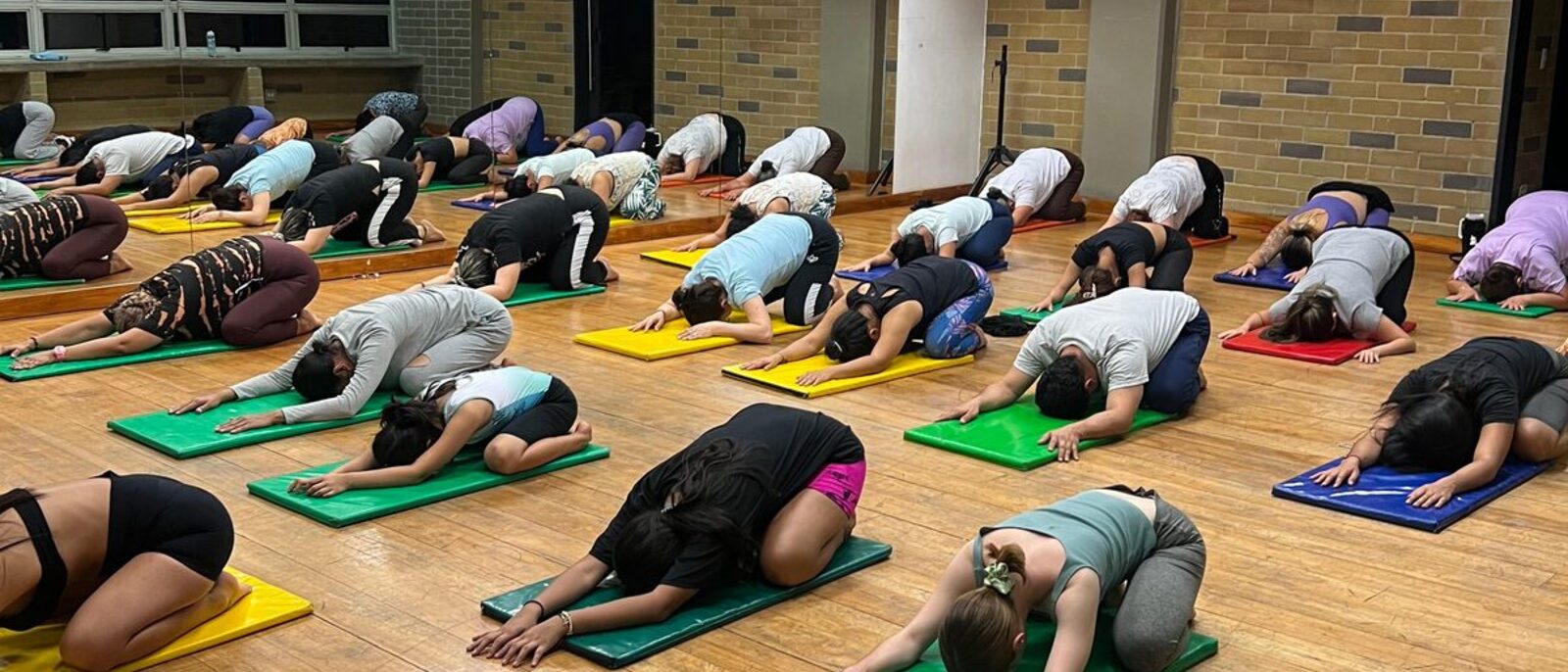 Clase de yoga en el estudio: alumnas en postura del niño